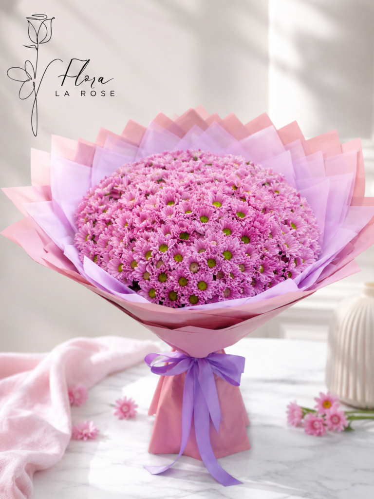 Pink chrysanthemum bouquet beautifully wrapped in pink and lavender paper with a purple ribbon – Flora La Rose Dubai